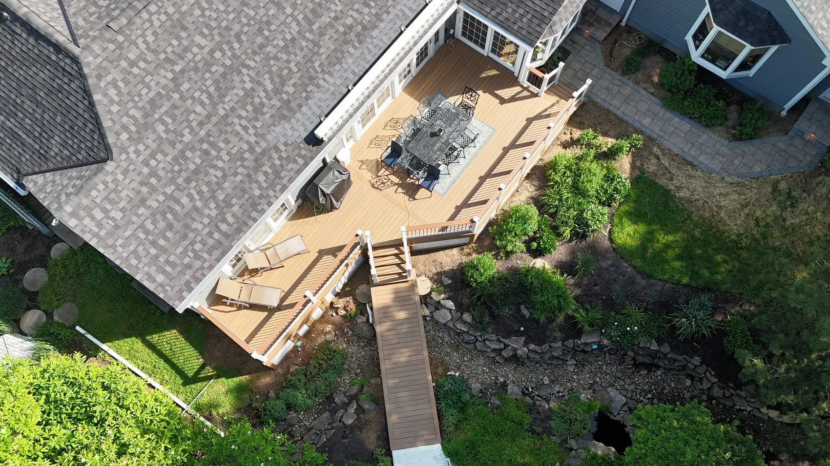 Aerial view of a multi level deck with separate dining and lounge areas