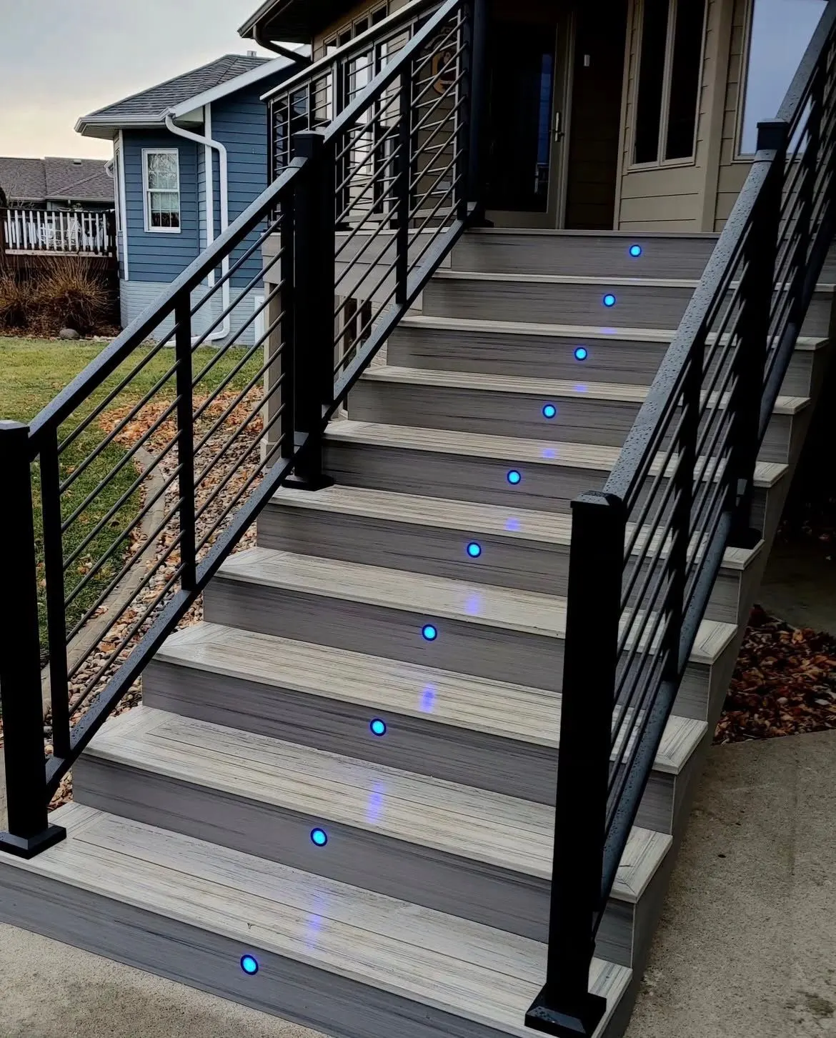Composite stairs with horizontal black railing running alongside