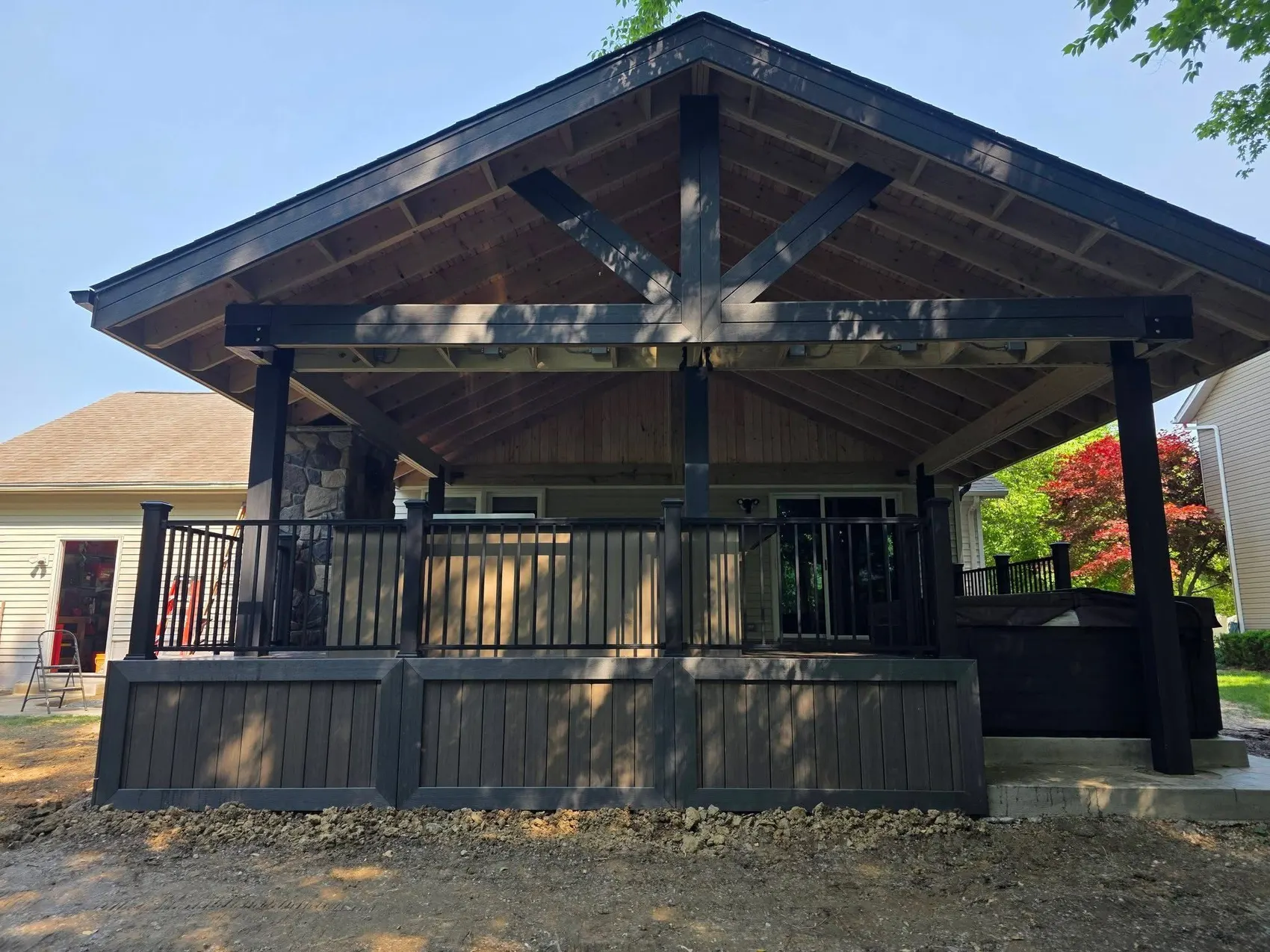 Covered outdoor space with a cedar lined ceiling over a composite deck