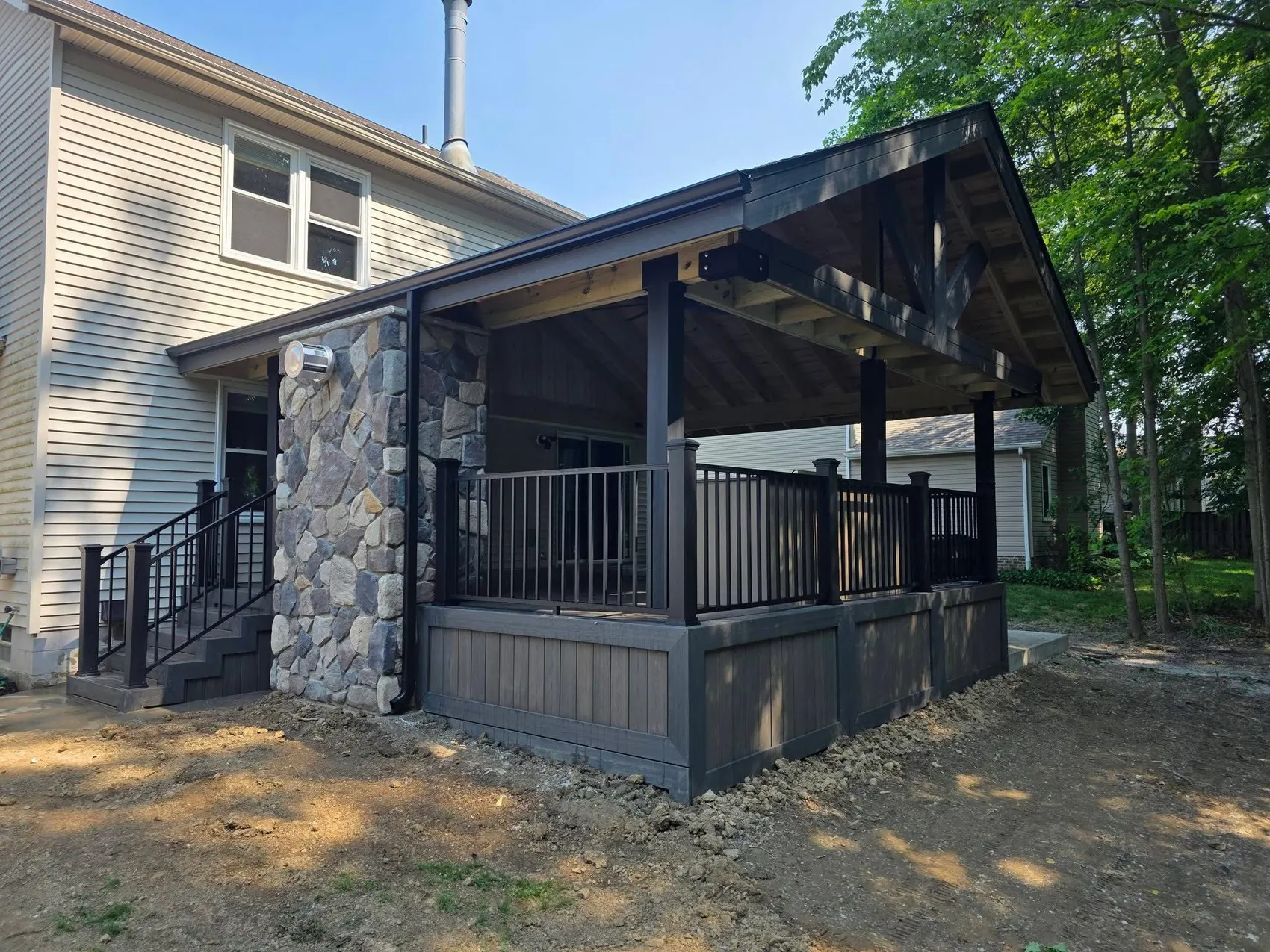 Covered porch with a stone column supporting the roof