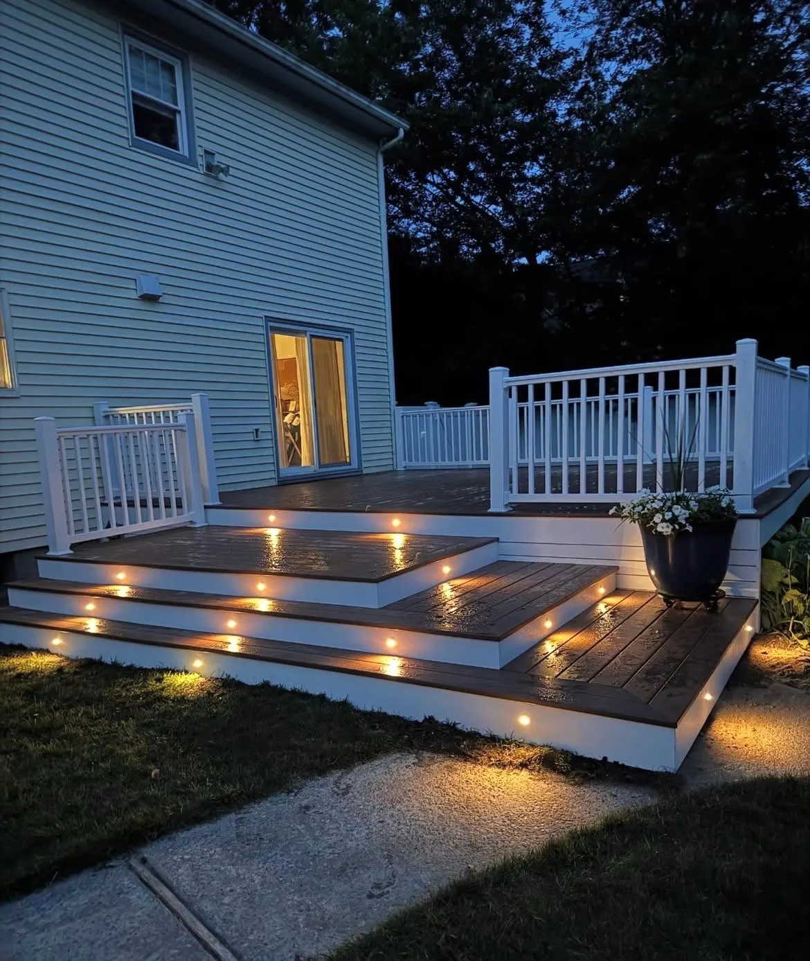 Multi level composite deck lit at dusk