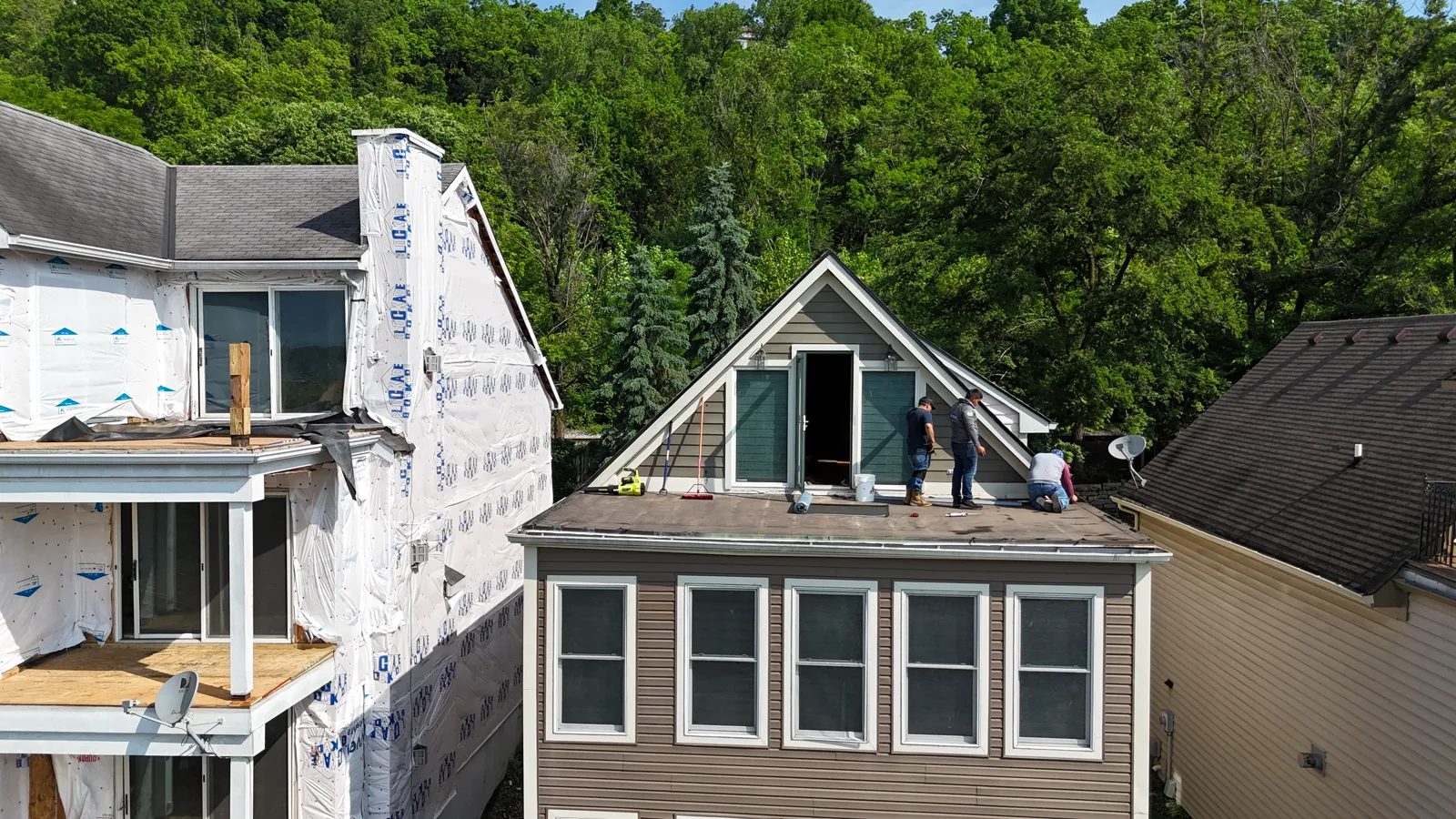 Flat roof section with the crew working on it, before the rooftop deck was built