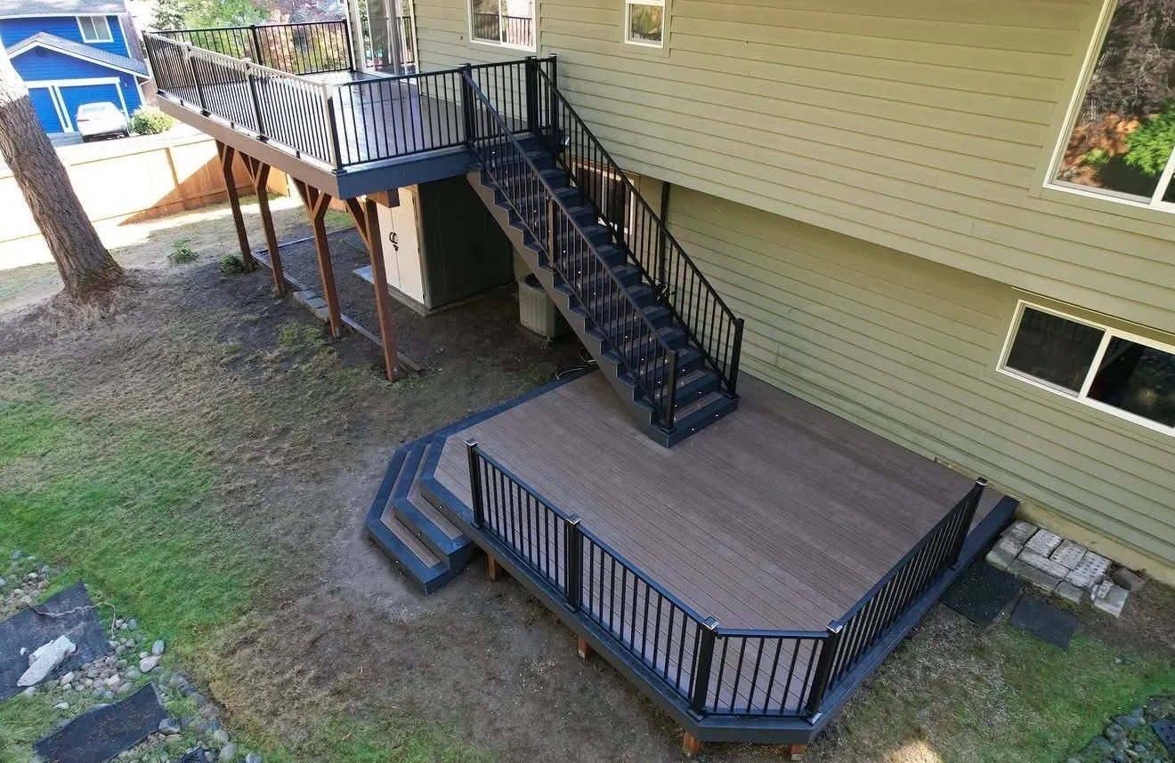 Two level composite deck with a long staircase down to the lawn
