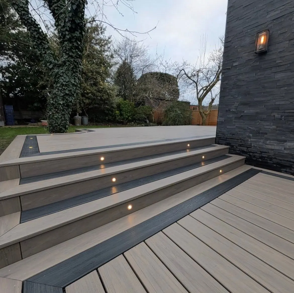 Wide composite deck steps with lights inset into the risers